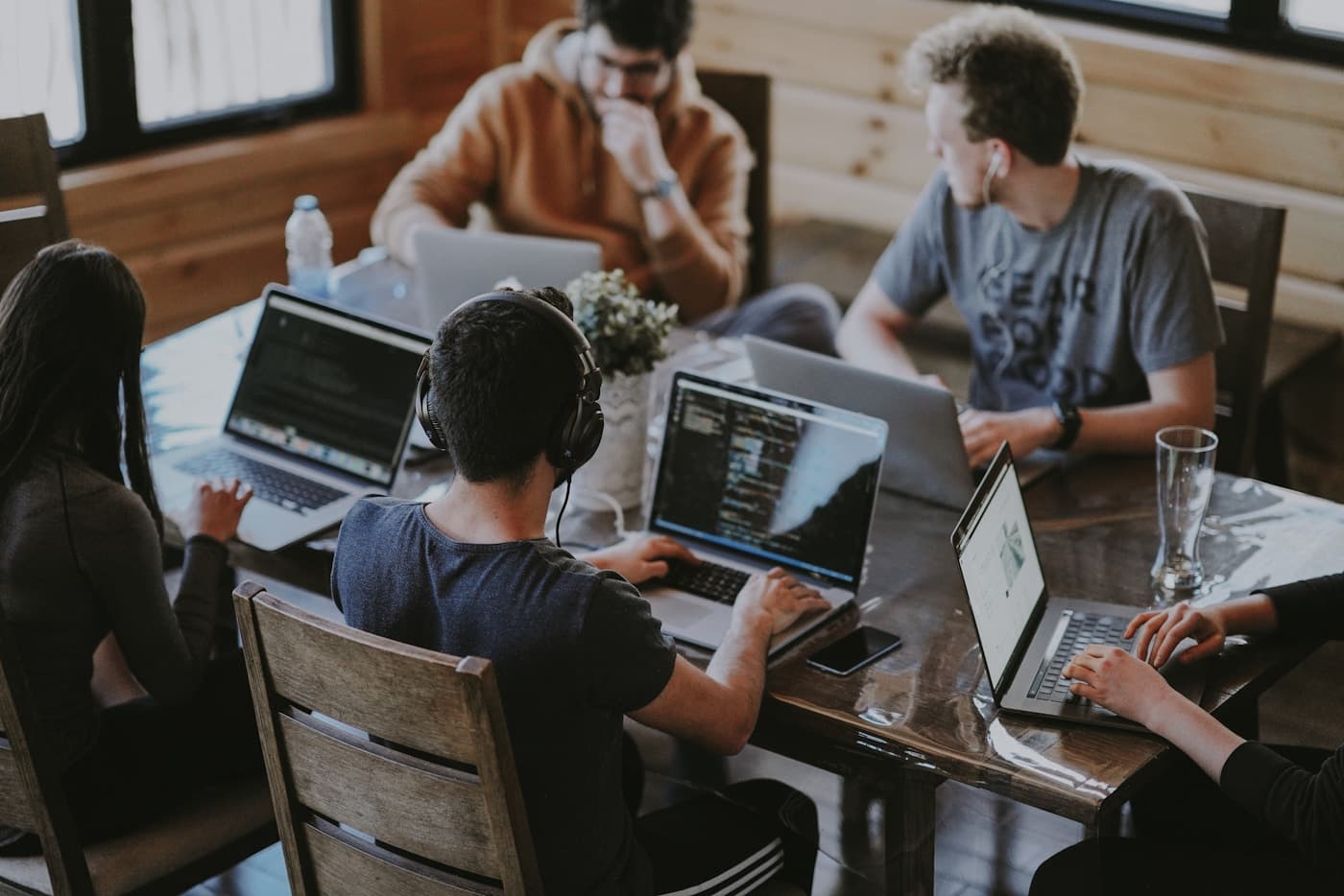 Small team collaborating with secure devices and shared security dashboard