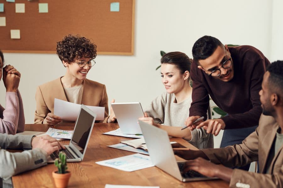 Small team coordinating securely on phones and laptops