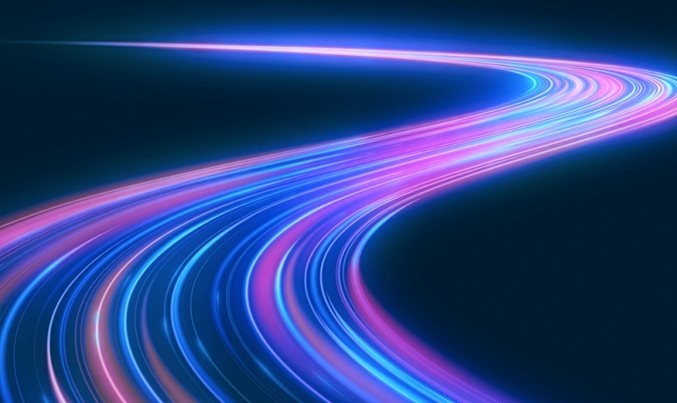 Blue and pink light trails on a dark background