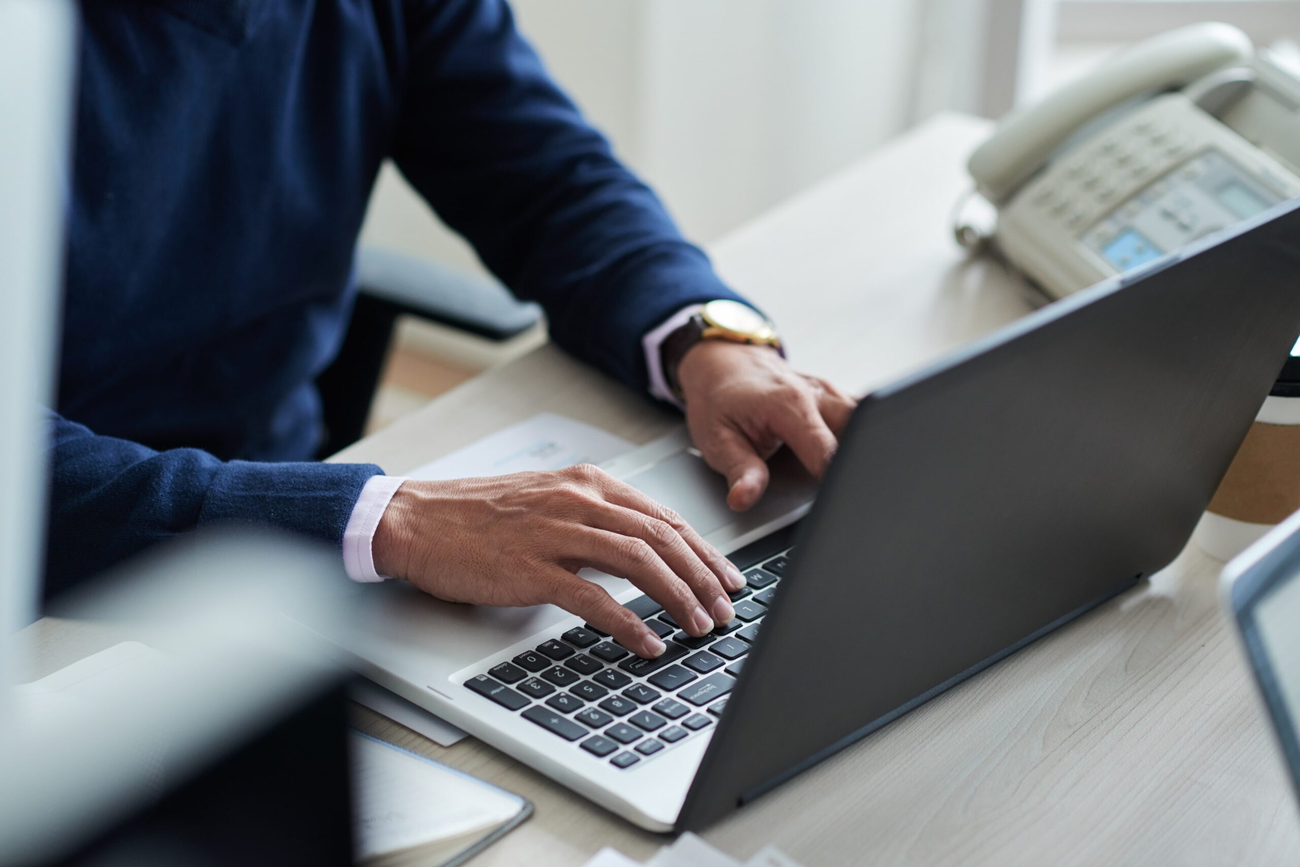 Professional working on a laptop at a desk